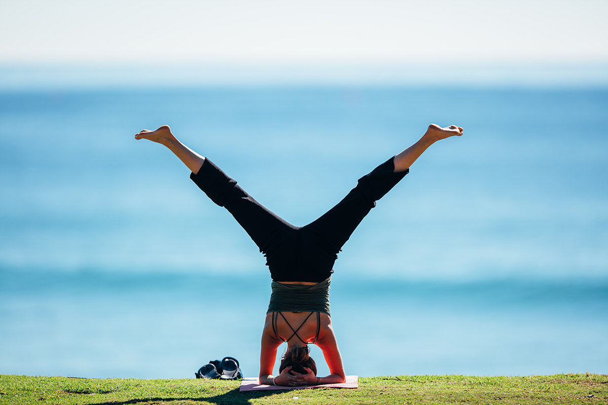 Woman doing yoga (image courtesy of Destination Gold Coast)