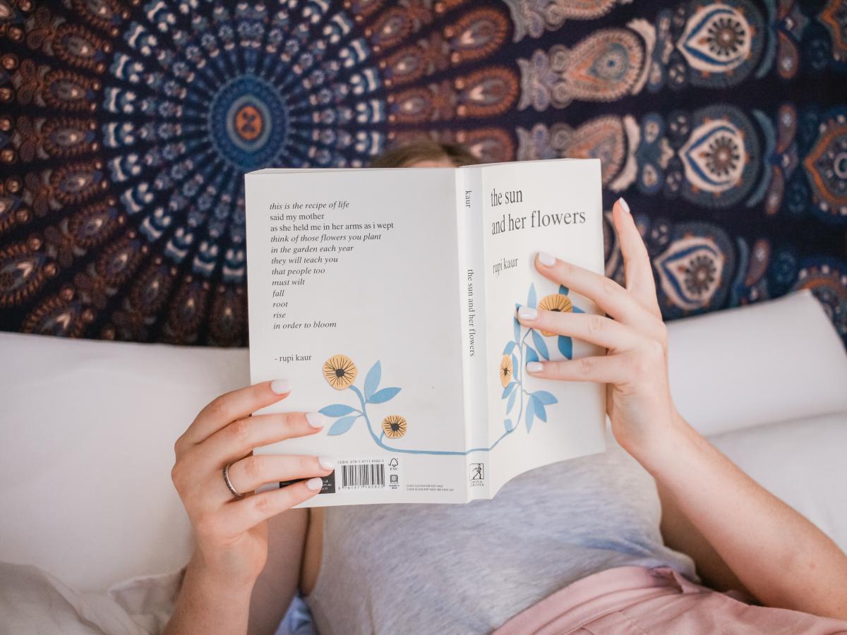 Woman reading book in bed (image supplied)