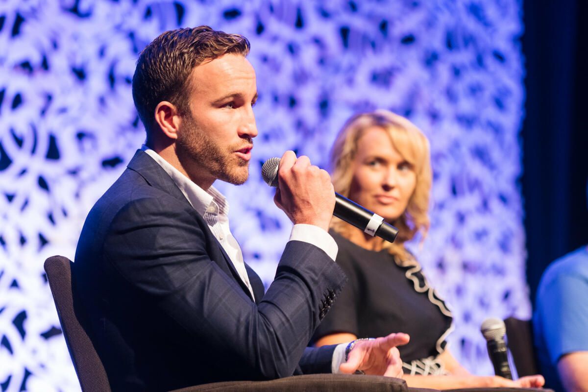 Sam speaking at a conference (image supplied)