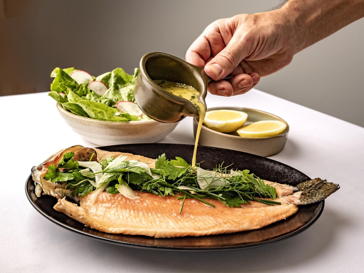 Grilled rainbow trout, herb & fennel salad, lemon beurre blanc from Gods of the Sea, Marina Mirage (image supplied)