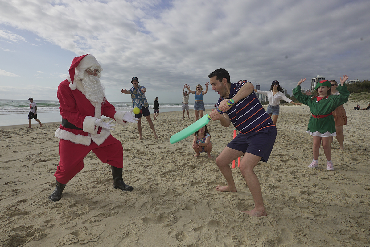 David playing beach cricket with Santa (image supplied)