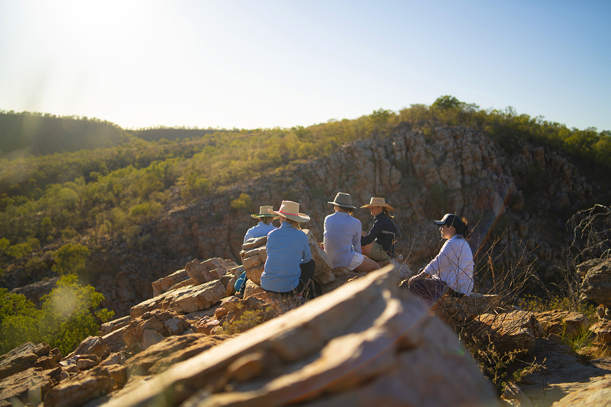 Group hiking through the rugged landscape (image supplied by Tourism and Events Queensland)