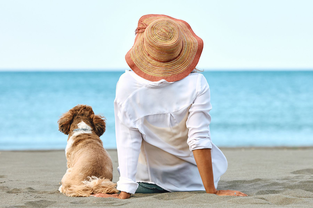 Woman and a dog on the beach (image supplied)